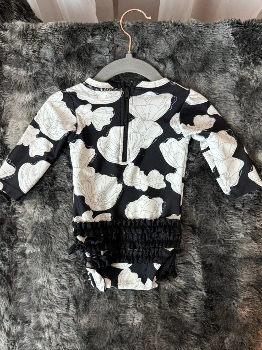 Rufflebutts Black Floral Long Sleeve Rashguard Swimsuit with White Flower Print